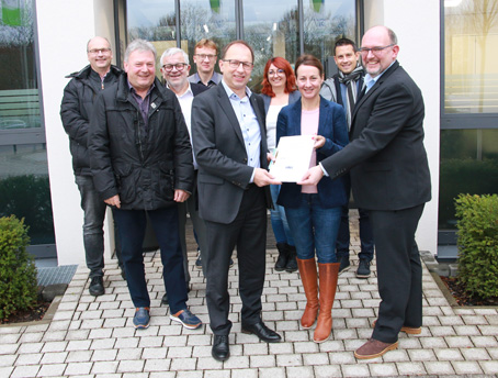 Zufrieden mit ihrem Handbuch: Rechtsanwalt Dr. Christoph Mayer,  Klimaschutzmanagerin Daria Paluch und Bürgermeister Markus Conrad (v.r.n.l. vorne)..